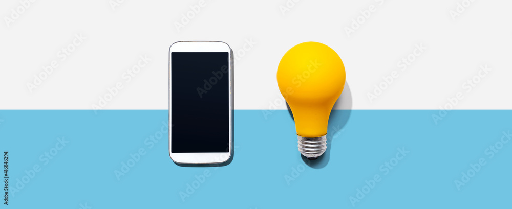 Smartphone with a yellow light bulb from above