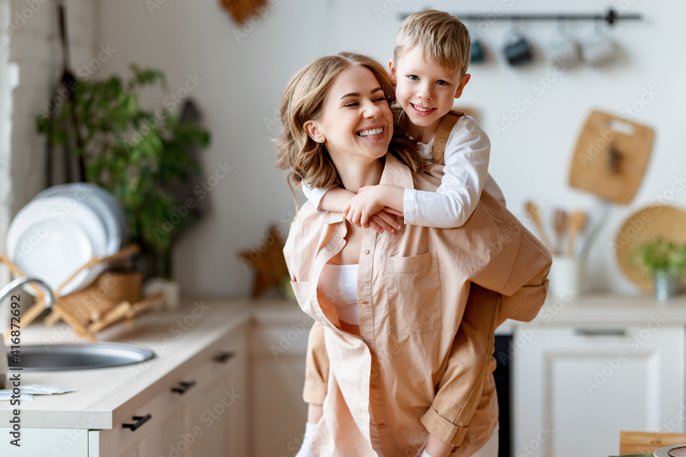 Mother playing with son in kitchen