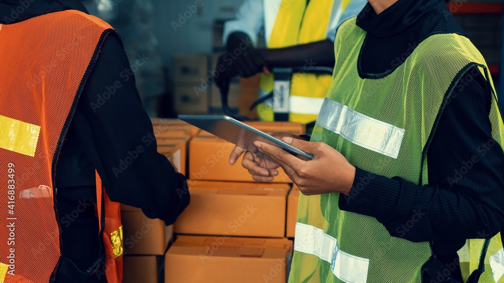 Warehouse worker working together in the storehouse . Logistics , supply chain and warehouse busines