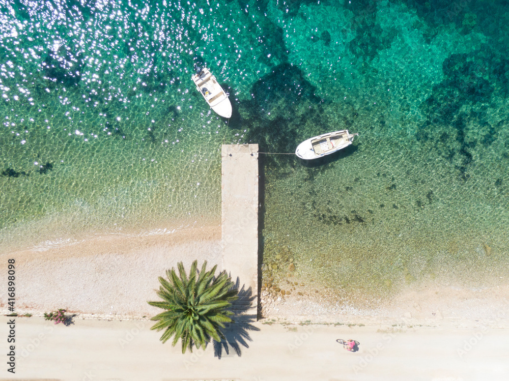 TOP DOWN Idyllic shot of a tourist cycling down empty coastal street in Peljesac