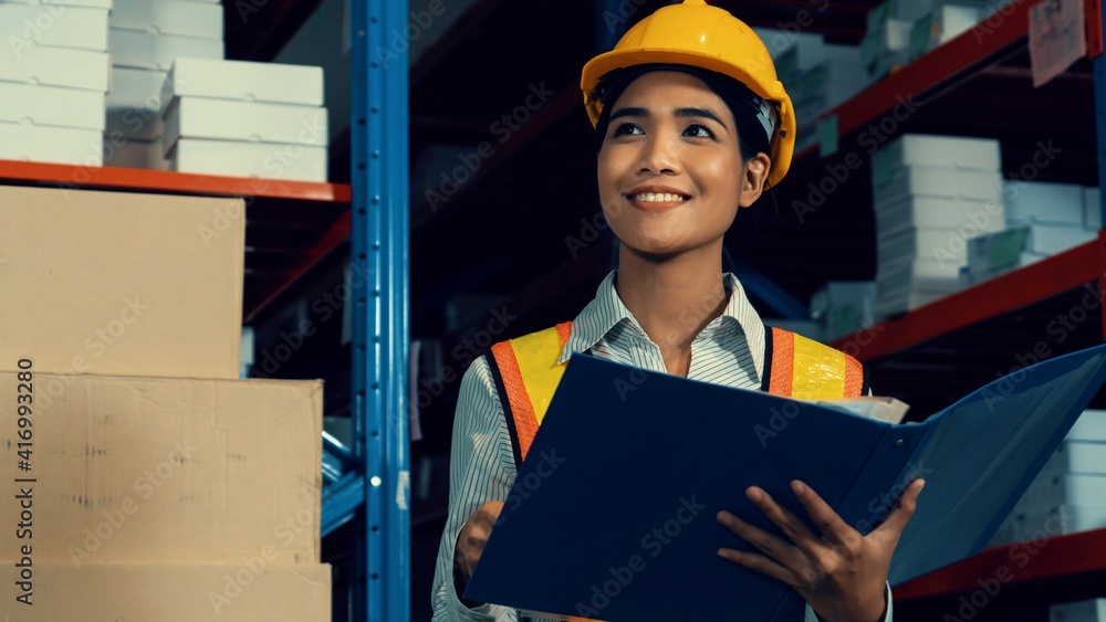 Female warehouse worker working at the storehouse . Logistics , supply chain and warehouse business 