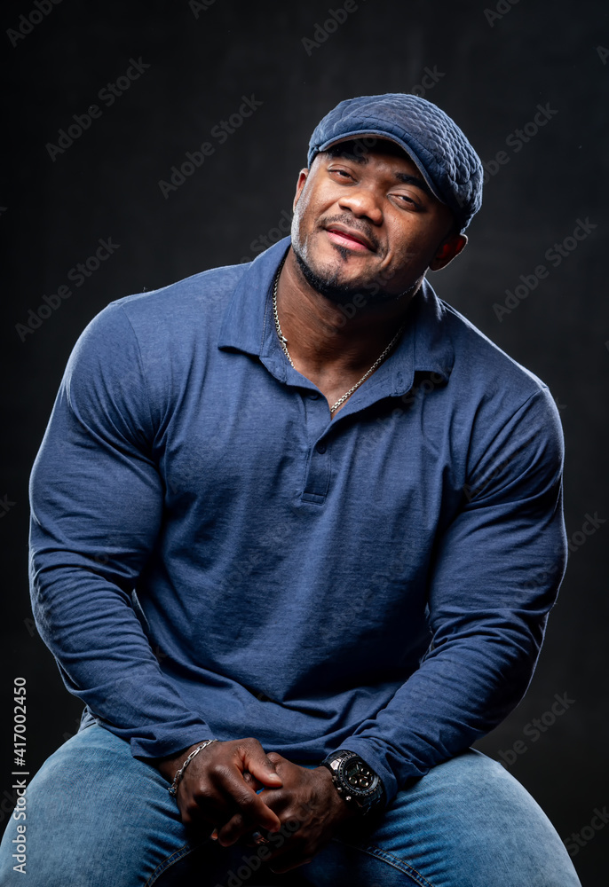 Portrait of a young african american man smiling on gray background