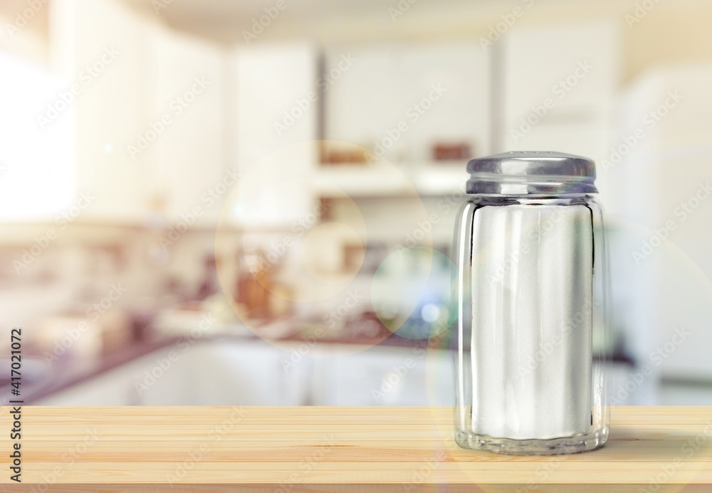 The salt glass bottle on the kitchen desk