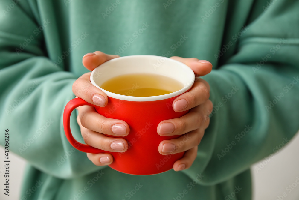 Woman with cup of hot tea, closeup