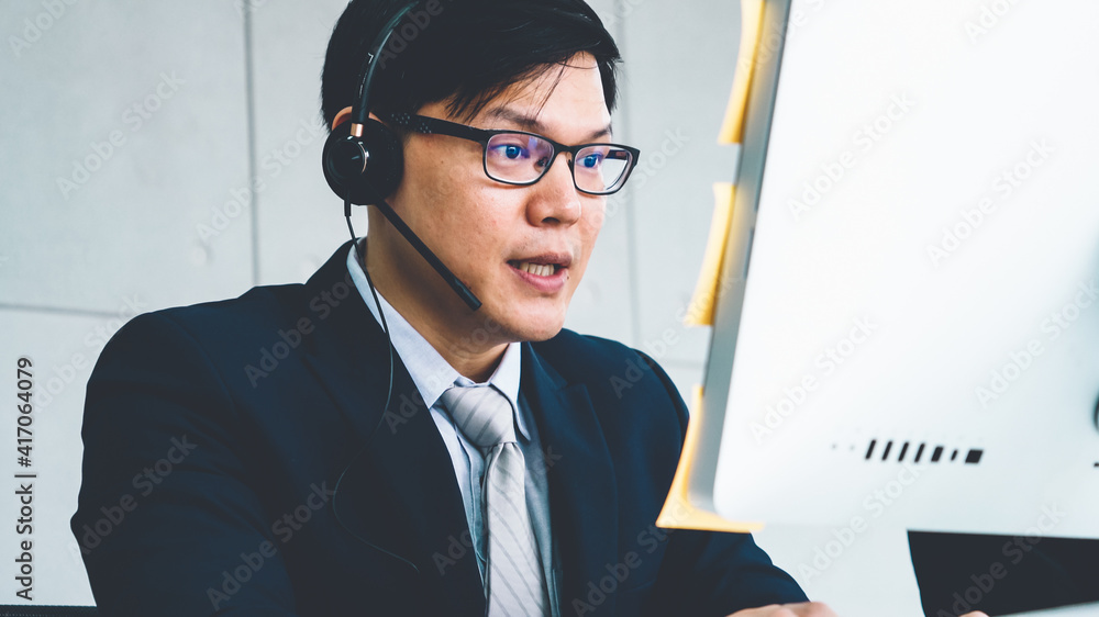 Business people wearing headset working in office to support remote customer or colleague. Call cent