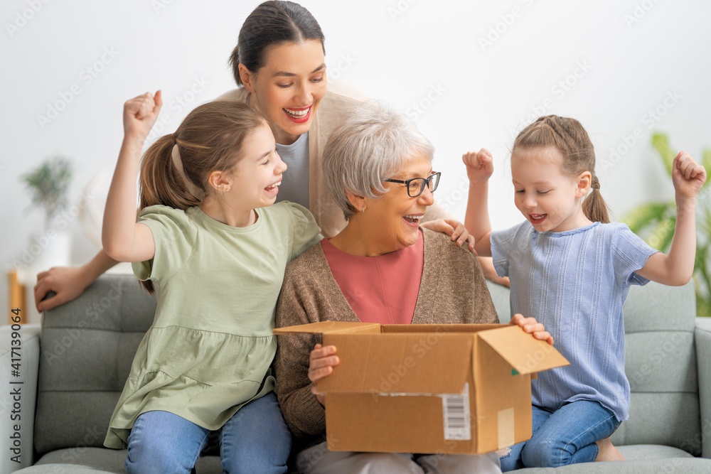 family unpacking cardboard box