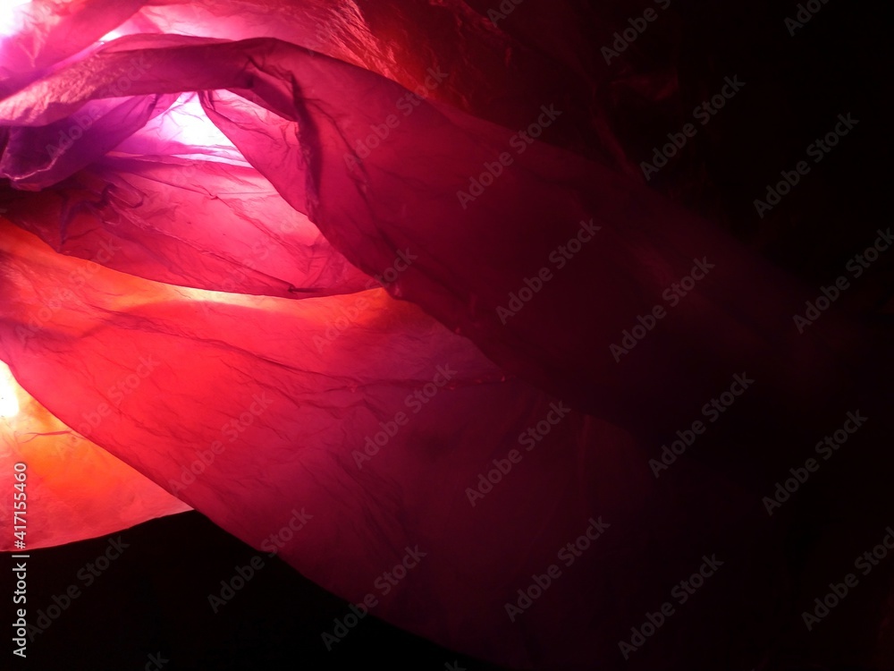 abstract from used plastic bag material in red and purple