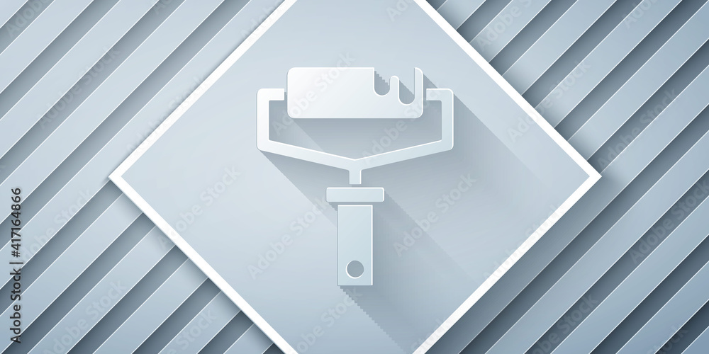 Paper cut Paint roller brush icon isolated on grey background. Paper art style. Vector.