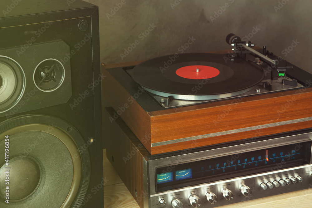 HiFi system with turntable, amplifier, headphones and lp vinyl records in a listening room