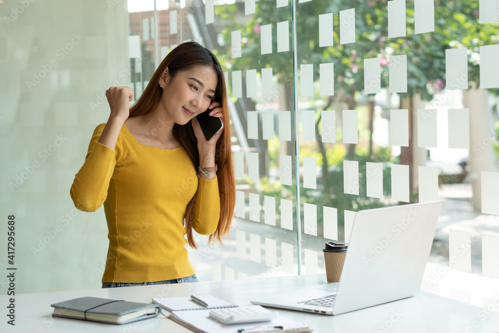 Happy Asian Businesswoman Talks to Mobile Customers for Demand and Sales Support at Modern Office, S