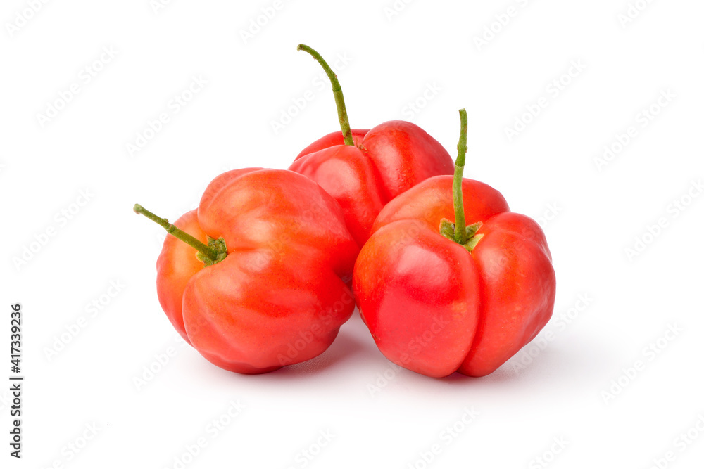 Group of three acerola cherry fruits on white background.