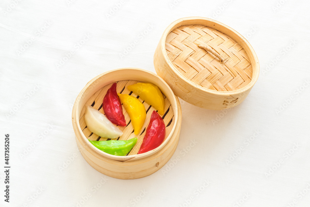 Asian steamed dumplings in wooden steamer. Traditional Chinese dim sum set