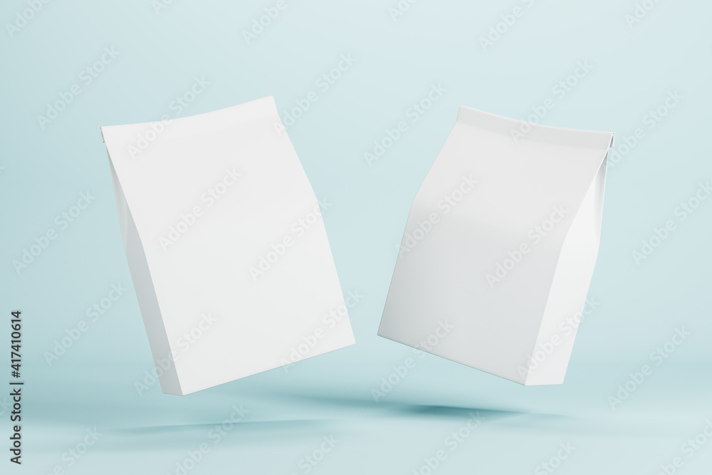 Two white paper bags with copyspace for your logo levitating in the air at blue background. Mock up