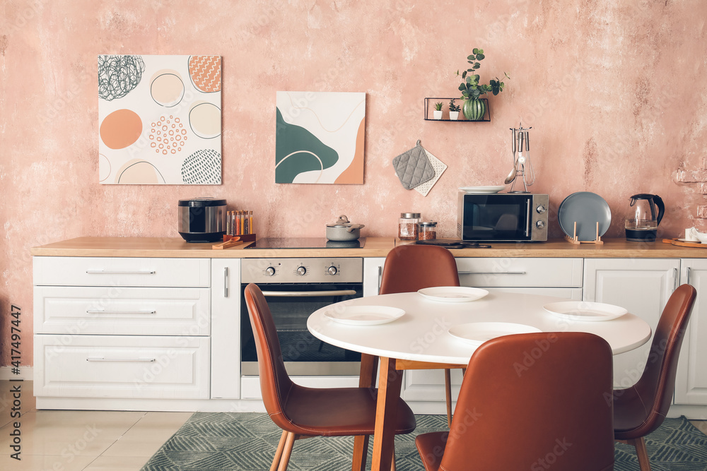 Stylish interior of modern kitchen with dining table