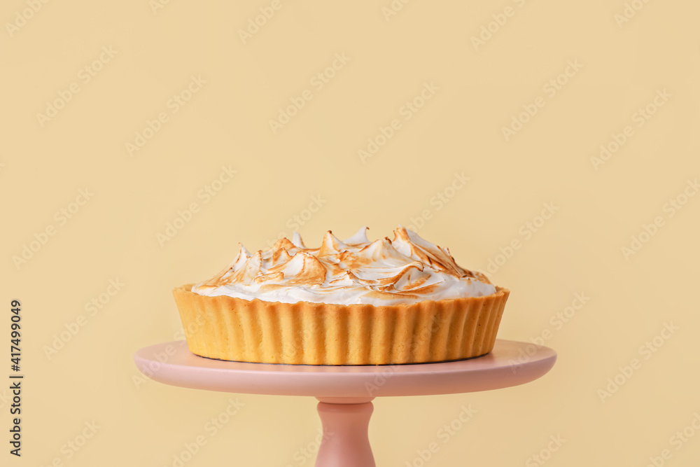 Dessert stand with tasty coconut pie on color background