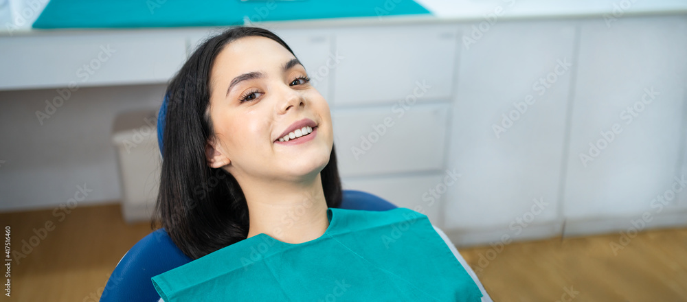 Portrait of Caucasian girl patient smiling, waiting for oral treatment