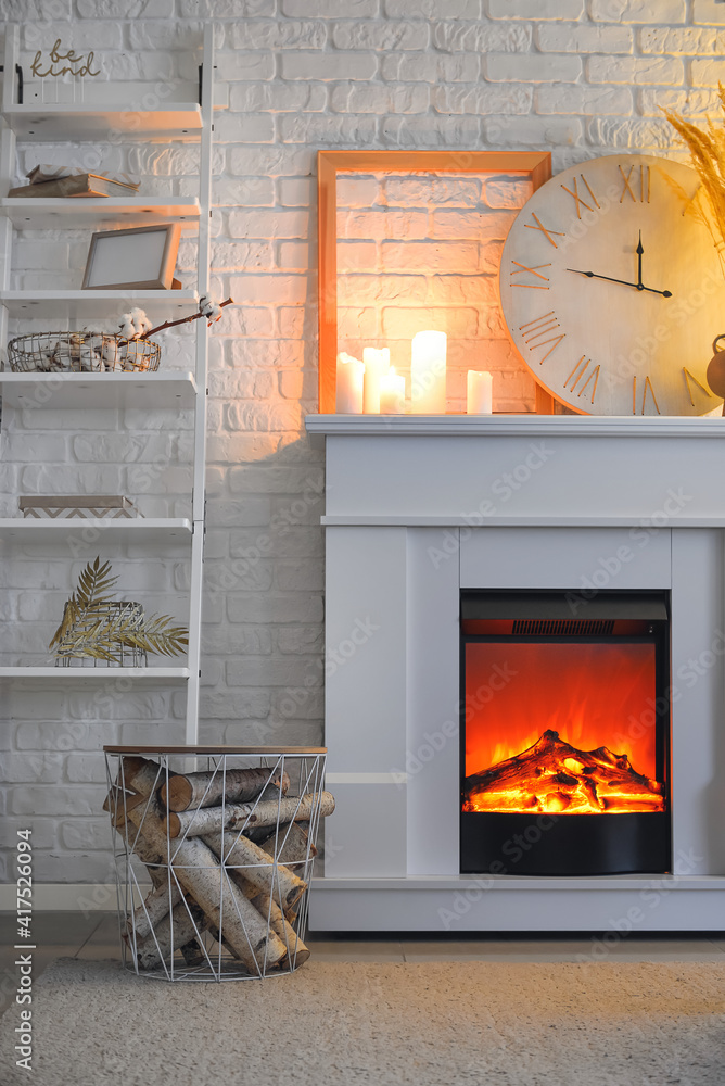 Interior of living room with fireplace in evening