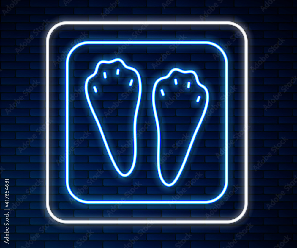 Glowing neon line Rabbit and hare paw footprint icon isolated on brick wall background. Vector.