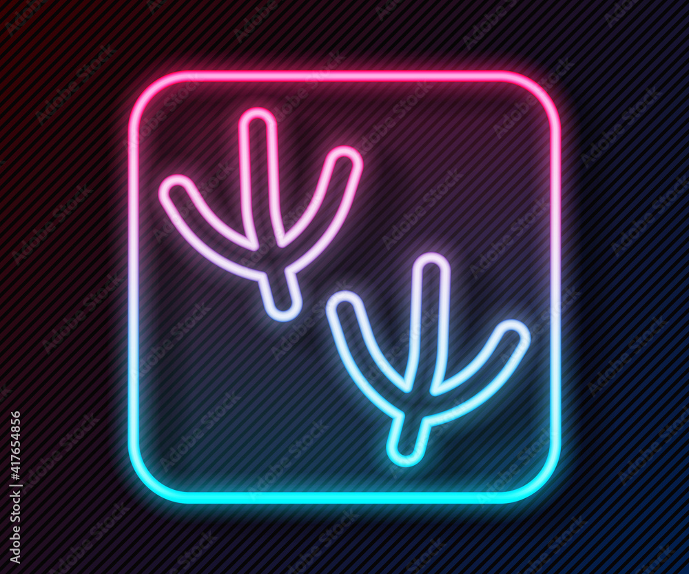 Glowing neon line Dove paw footprint icon isolated on black background. Vector.