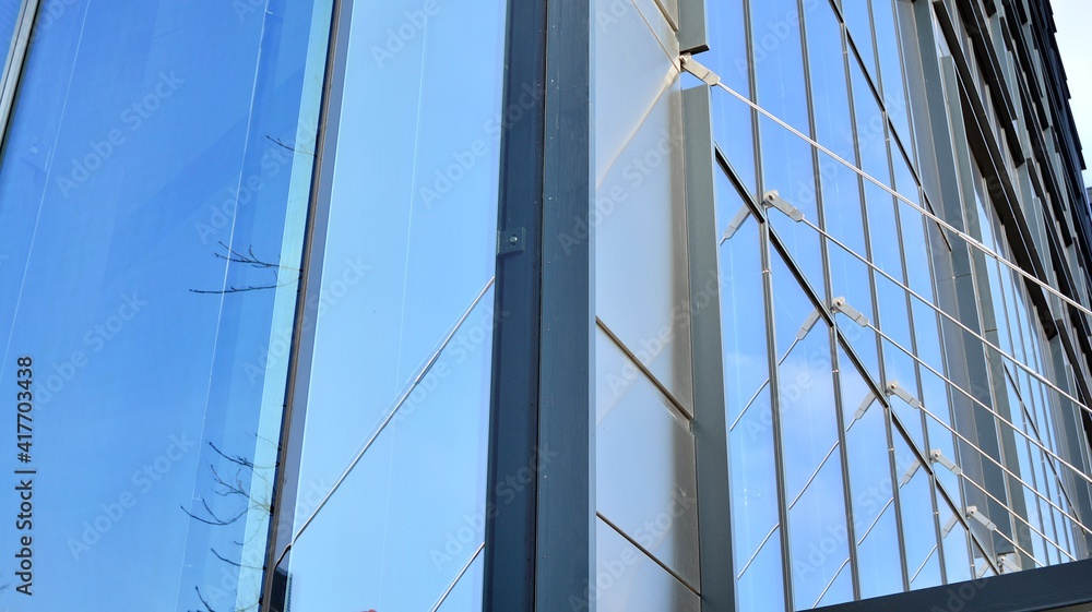 Fragment of glass and metal facade walls. Commercial office buildings. Abstract modern business arch