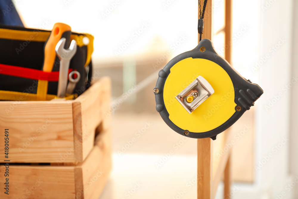 Measure tape and construction tools in workshop, closeup