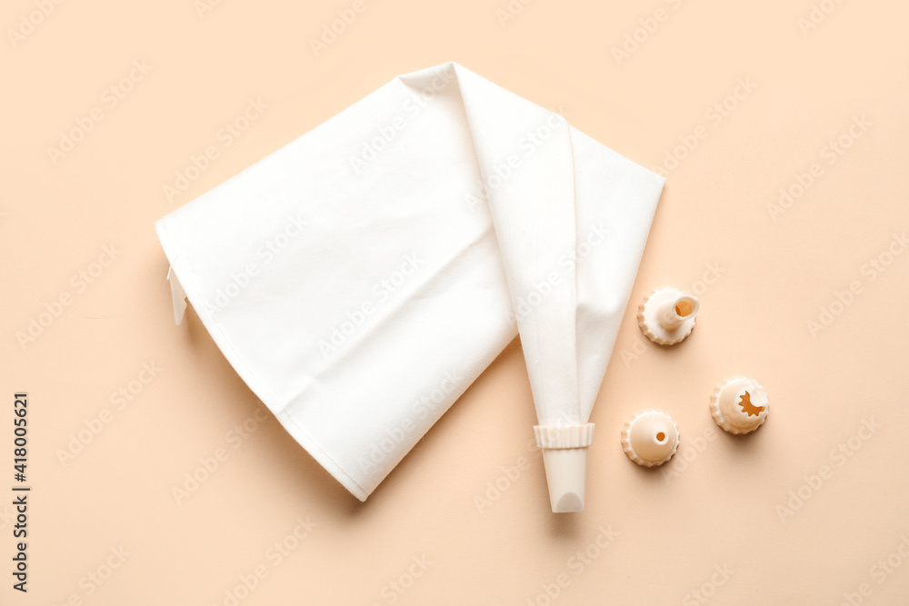 Pastry bag and different tips on color background