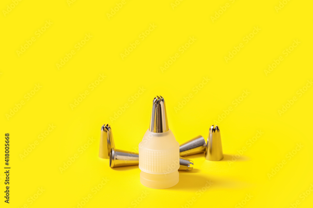 Different piping tips on color background