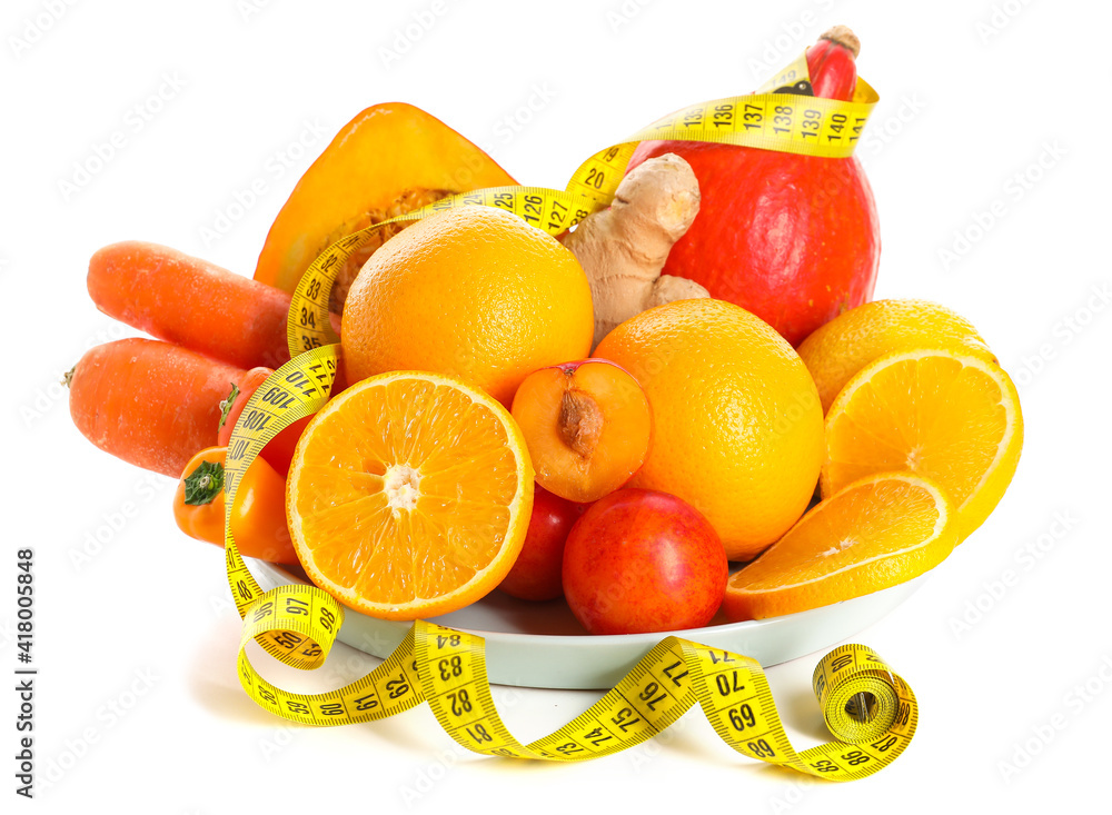 Plate with healthy products and measuring tape on white background