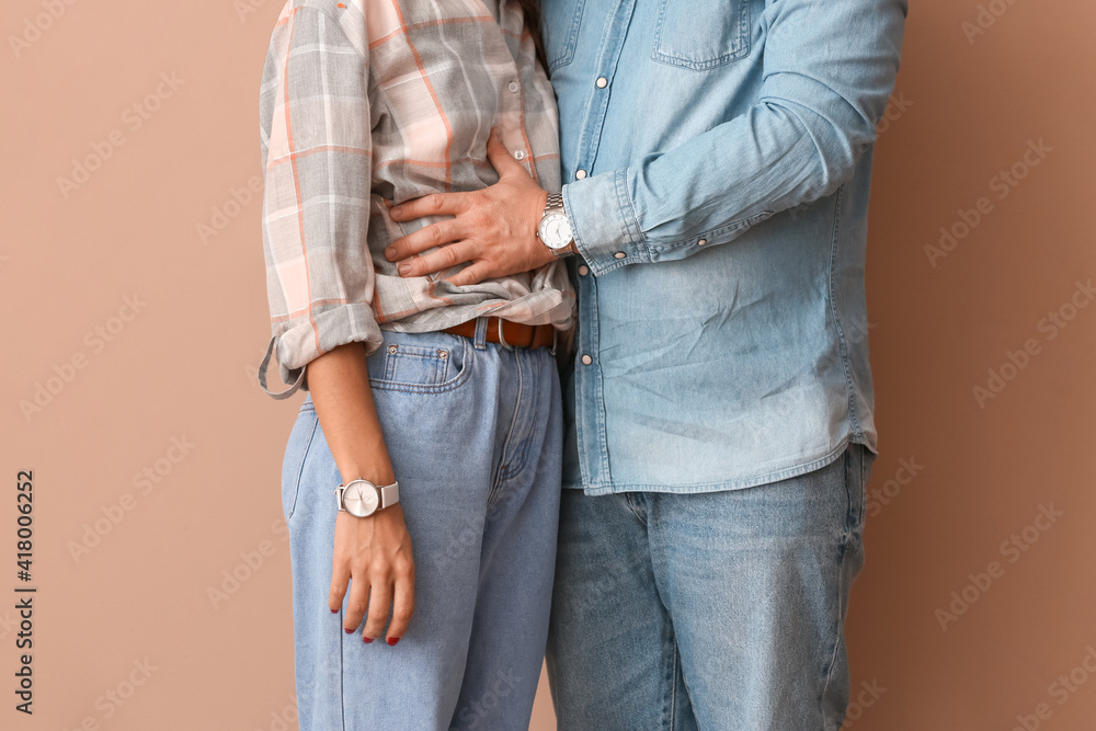 Happy young couple on color background