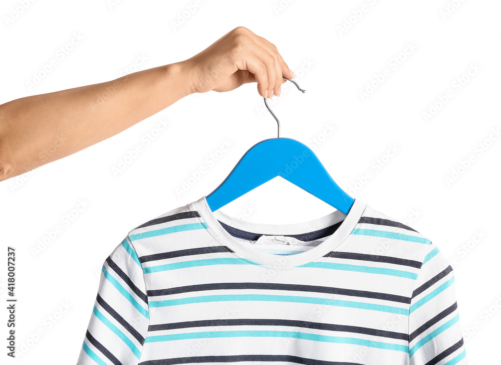 Woman holding hanger with t-shirt on white background