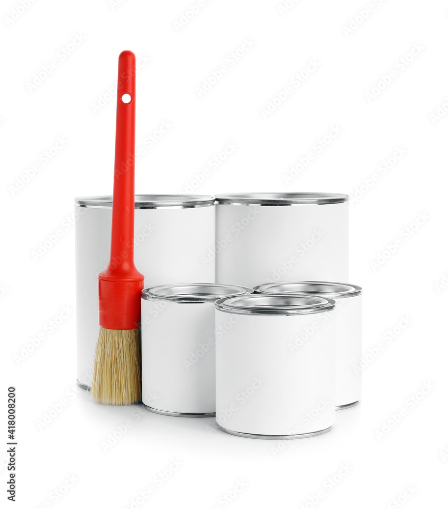 Cans of paint and brush on white background