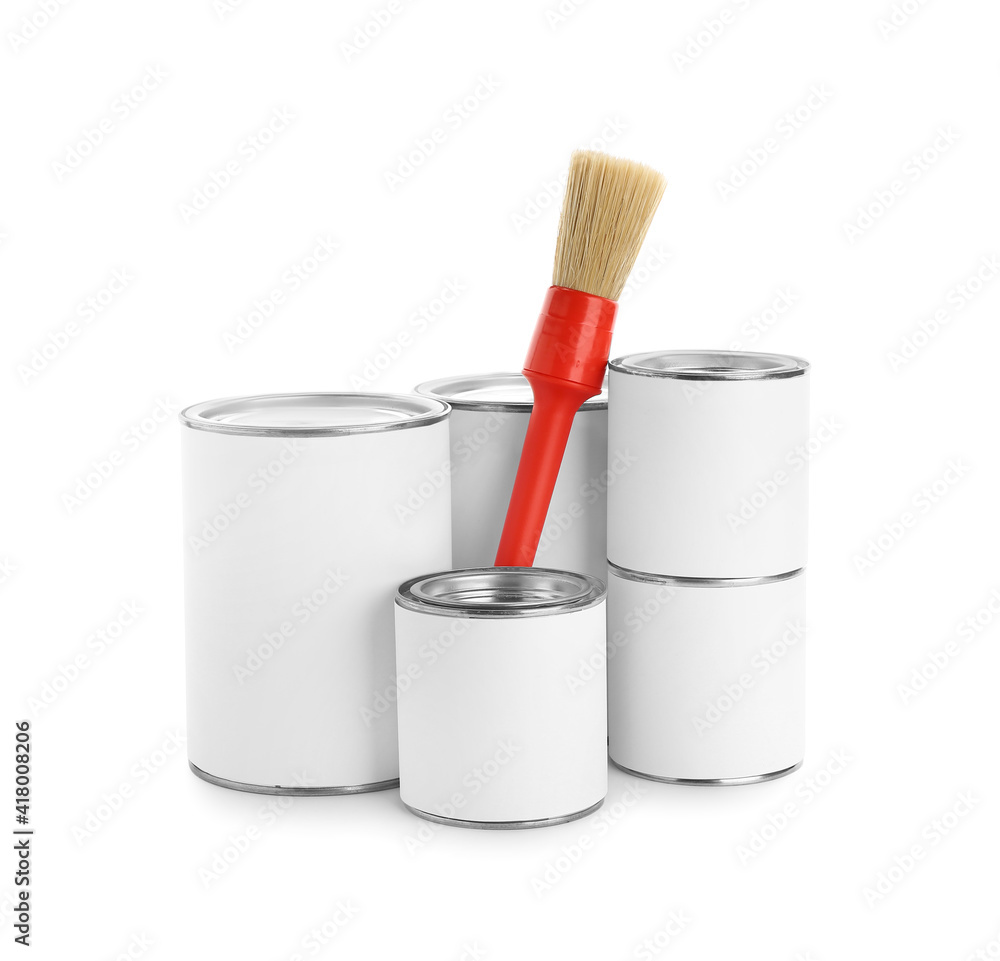 Cans of paint and brush on white background