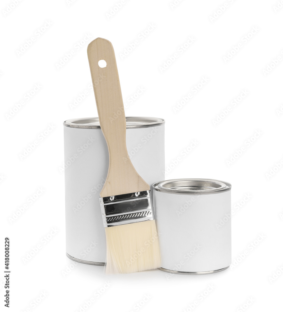 Cans of paint and brush on white background