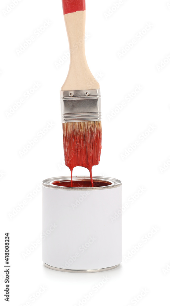 Brush and can with red paint on white background