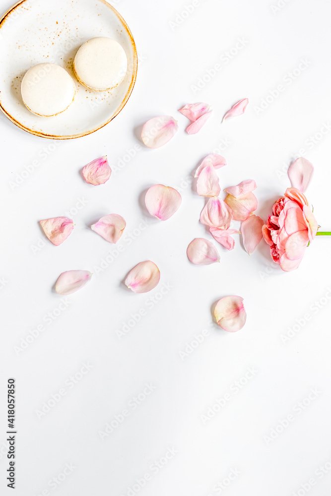 flat lay with petals and macaroons on white background top view mockup