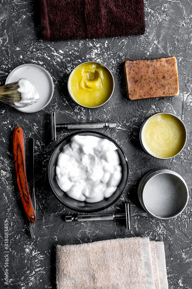 Tools for shaving in barbershop on workplace background top view