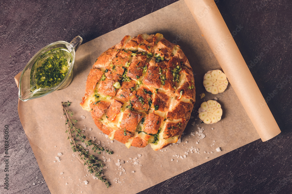 Fresh bread and garlic on dark background