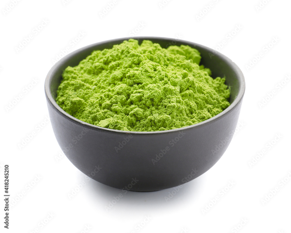 Bowl with powdered matcha tea on white background