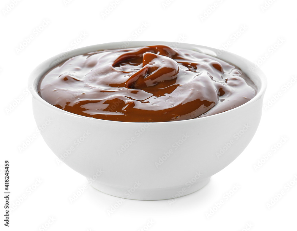 Bowl of boiled condensed milk on white background