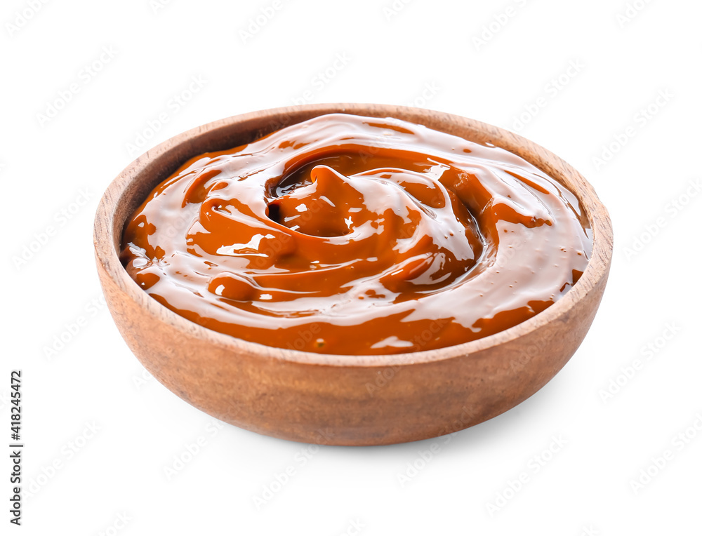 Bowl of boiled condensed milk on white background