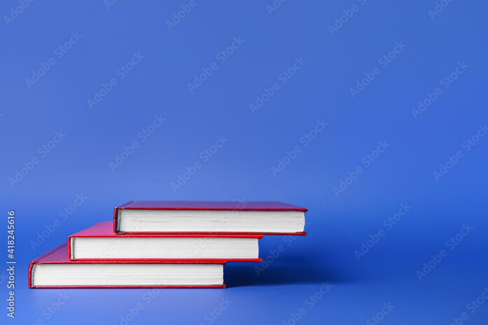 Blank books on color background