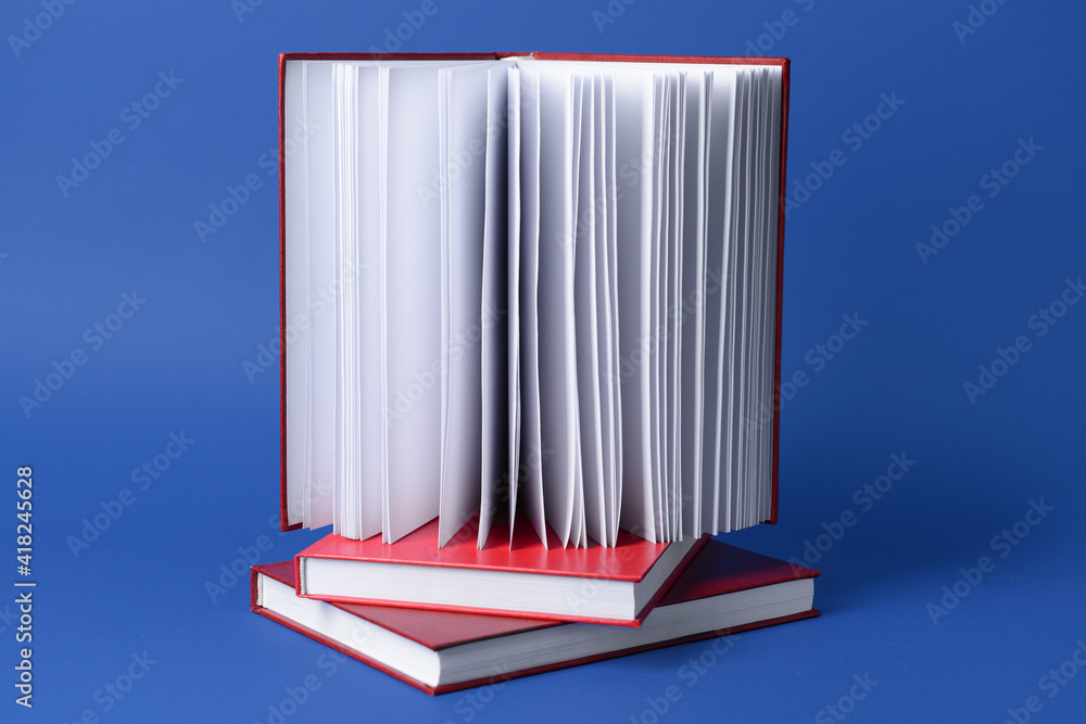 Blank books on color background