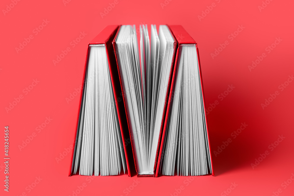 Blank books on color background