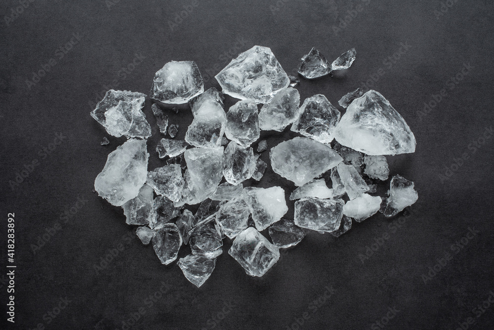 A pile of crushed ice cubes on a black background gourmet catering background