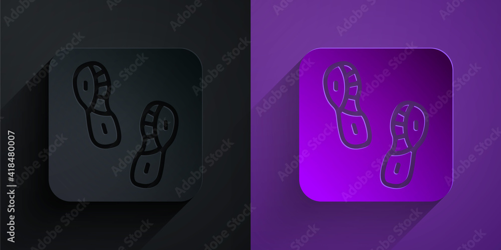 Paper cut Human footprints shoes icon isolated on black on purple background. Shoes sole. Paper art 