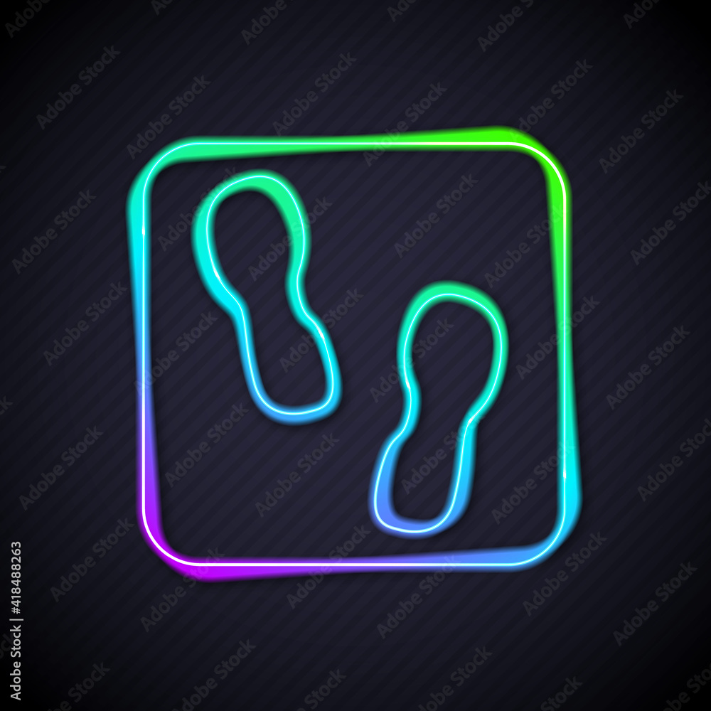 Glowing neon line Human footprints shoes icon isolated on black background. Shoes sole. Vector.