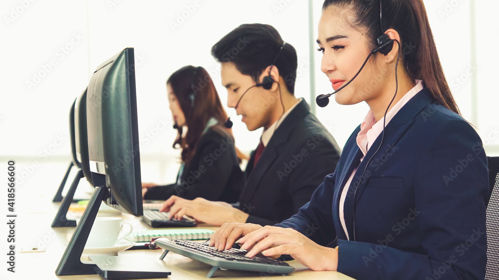 Business people wearing headset working in office to support remote customer or colleague. Call cent