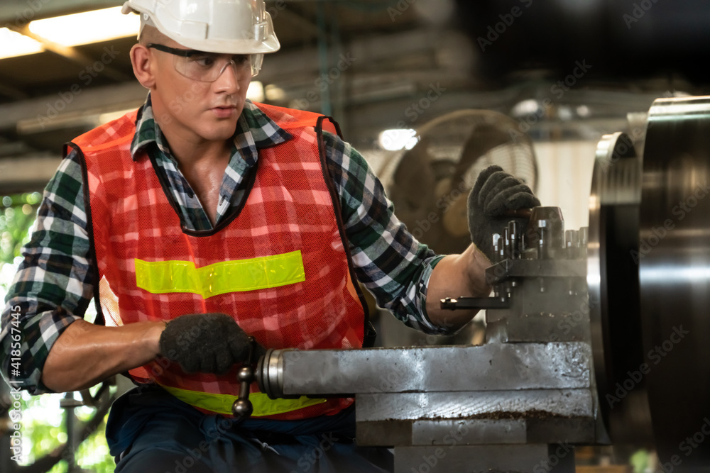 Smart factory worker or engineer do machine job in a manufacturing workshop . Industry and engineeri