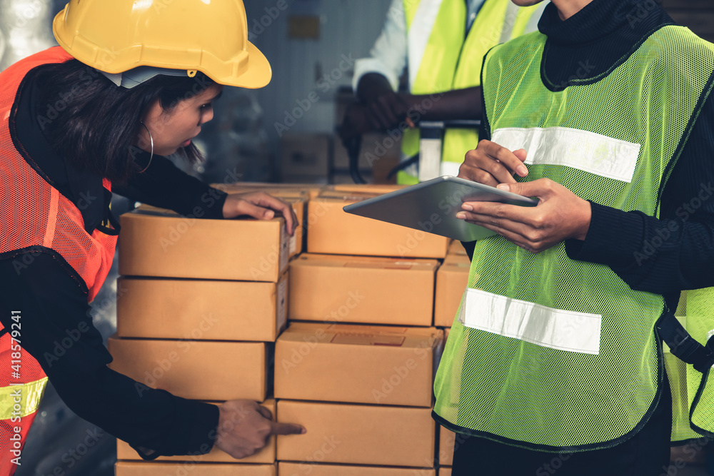 Warehouse worker working together in the storehouse . Logistics , supply chain and warehouse busines