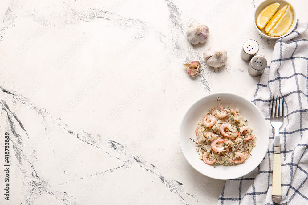 Plate with tasty risotto on light background